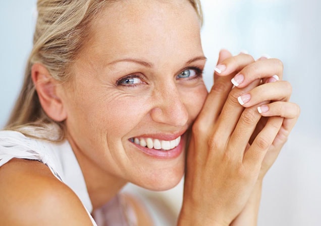 Woman smiling because of a new patient special she received at Princess Center Dentistry