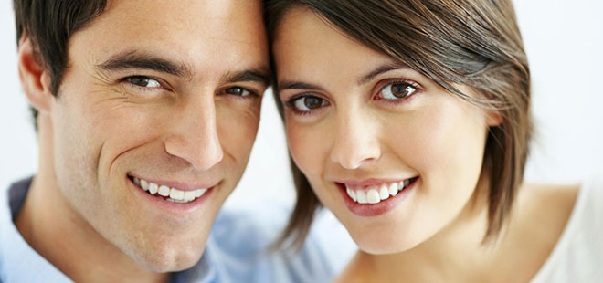 A couple smiling after receiving laser dentistry at Princess Center Dentistry